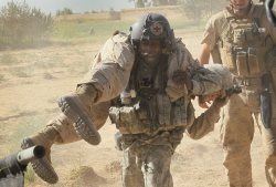 militaryarmament:  U.S. Army flight medic SGT Tyrone Jordan, attached to Dustoff Task Force Shadow of the 101st Combat Aviation Brigade carries Marine LCpl. David Hawkins to a MEDEVAC helicopter after he was wounded by a blast from an improvised explosive