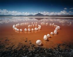 artchipel:  Scarlett Hooft Graafland (b.1973, Netherlands) The images Scarlett Hooft Graafland creates look impossible – but not unreal. Her method has parallels with that of a documentary maker. Coloured balls floating over a frozen pond with swans.