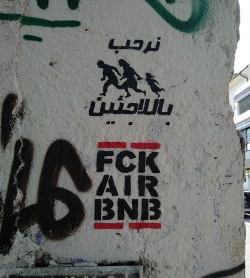 &ldquo;Refugees Welcome / FCK AirBNB&rdquo; Stencil seen in Ljubljana, Slovenia