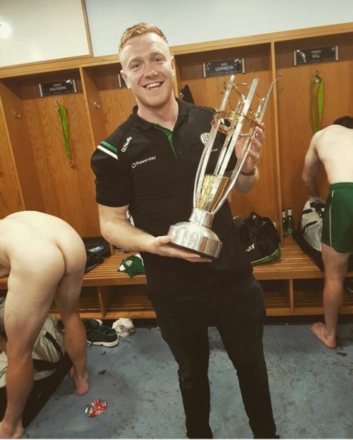 notdbd: The London Irish rugby locker room: One player (Conor Gilsenan) shows us the trophy, while h