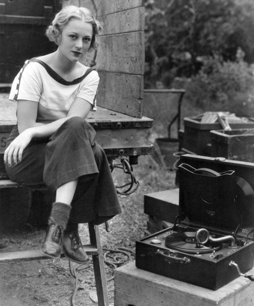 rustedshutter:Sally Eilers takes a break filming “Walls of Gold” to listen to a record; 1933