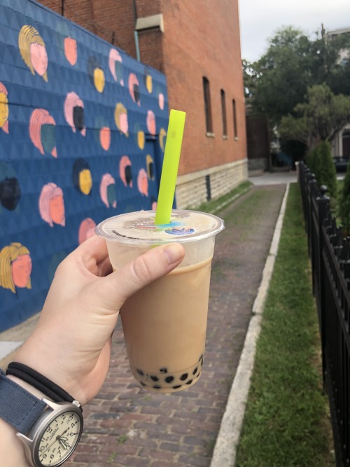 30/8/20Pictured: boba tea in an alley featuring a mural with a blue background and heads of women wi