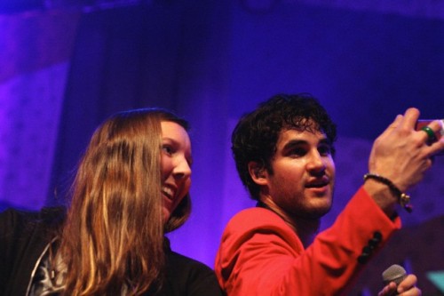 Darren Criss with a fan on stage in concert at The Fillmore in San Francisco, CA