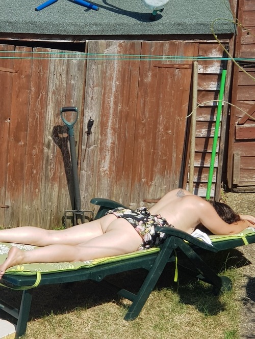 Sunbathing wife in garden
