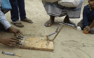 sixpenceee:Toy excavator made from syringes. (Source)