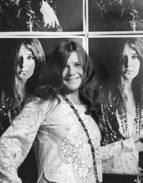 Janis posing in front of Bob Seiddmann poster, 1967.Photography by Baron Wolman.