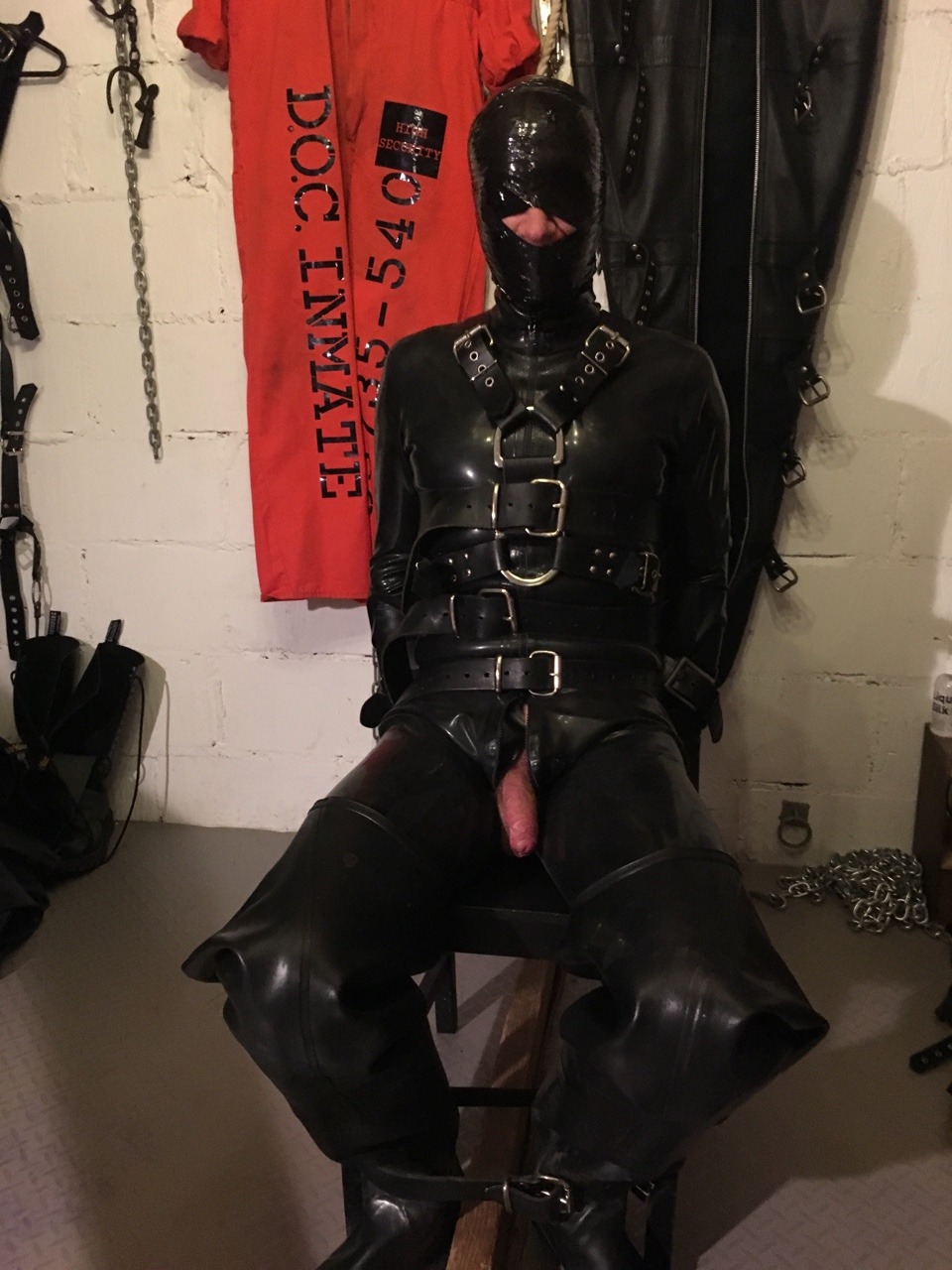 jamesbondagesx:  Rubber gimp strapped to chair, gagged, head mummified, gas masked