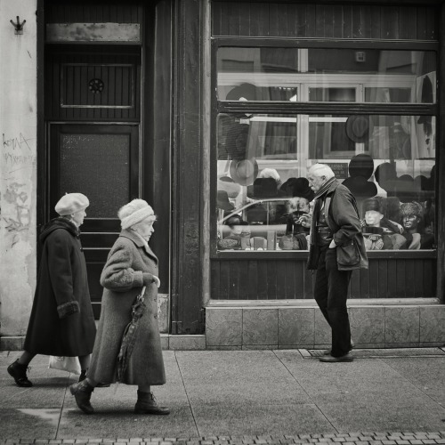 Having a hat was his wish so he bought one - just like Fish. People walking on the street of Wroclaw