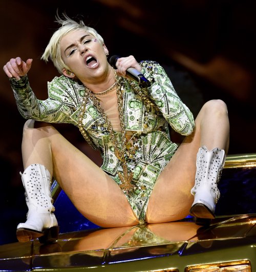 pornwhoresandcelebsluts:  Miley Cyrus does more slutty spread leg crotch shots live in concert on the Bangerz tour