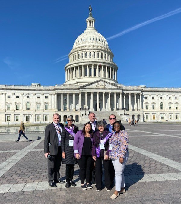 Volunteer advocates and Alzheimer's Association staff pose for a picture in front of the United States Capitol Building.