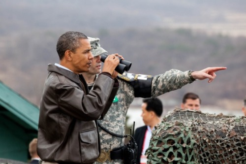 President Barack Obama is briefed by Lt. Col. Ed Taylor as he views the DMZ from Observation Post Ou