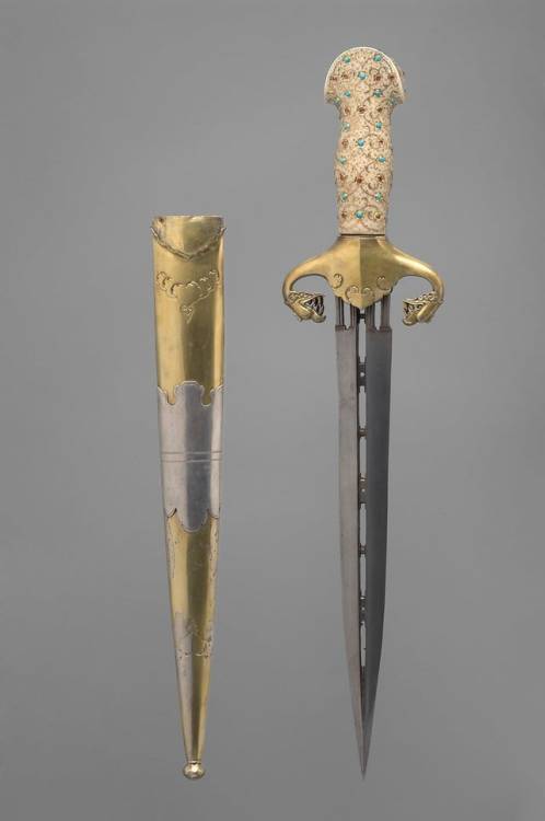 A beautiful pierced dagger with an ivory grip studded with turquoise and rubies and gilded quillons,