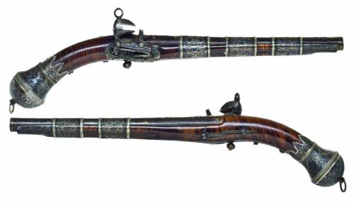 A pair of silver mounted miquelet pistols originating from the Caucuses, 19th century.