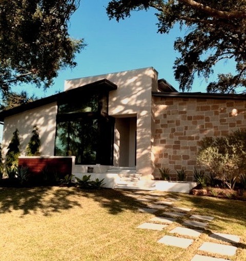 Tampa MetalMid-sized 1950s Beige Two-story Stone Exterior Home Photo With A Metal Roof