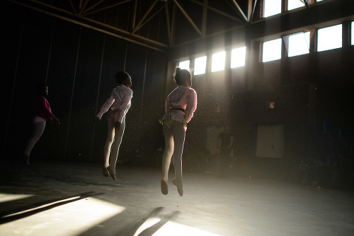 Young ballerinas warm up before training in the Soweto township of Johannesburg, South Africa. (Phot