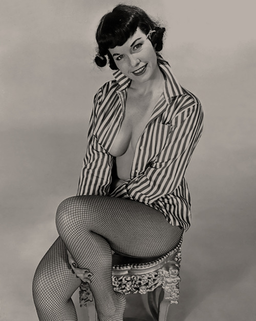 Bettie Page on a stool.
