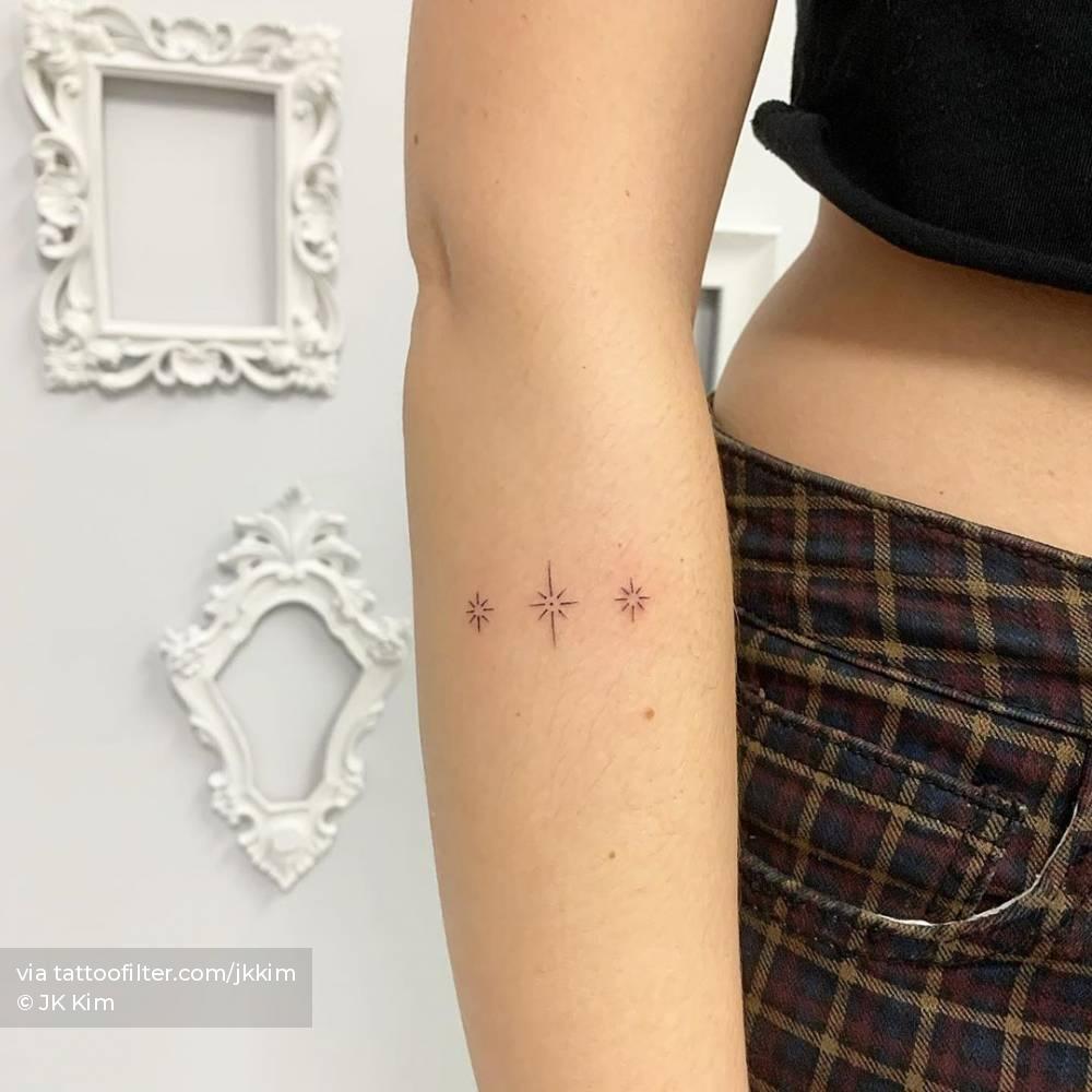 Grey Ink Twinkling Star Tattoo On Girl Back