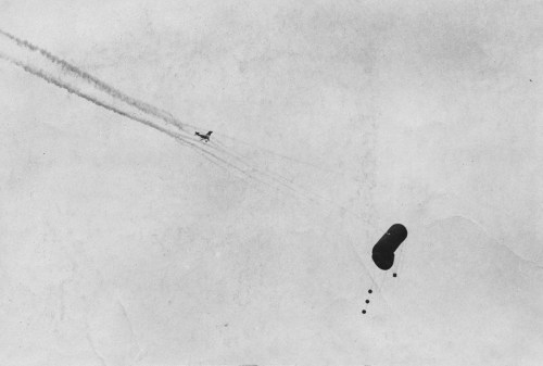 A German balloon being shot down (WW1).An aircraft falls from the sky in flames (WW1).