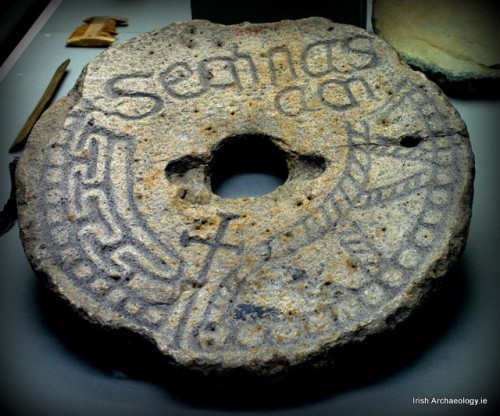 irisharchaeology:A quern stone for grinding grain which was reused as a grave marker at Clonmacnoise