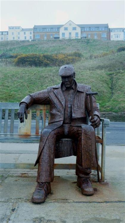 Freddie Gilroy sits on North Bay, Scarborough, North Yorkshire, England.A friend of the sculptor Ray