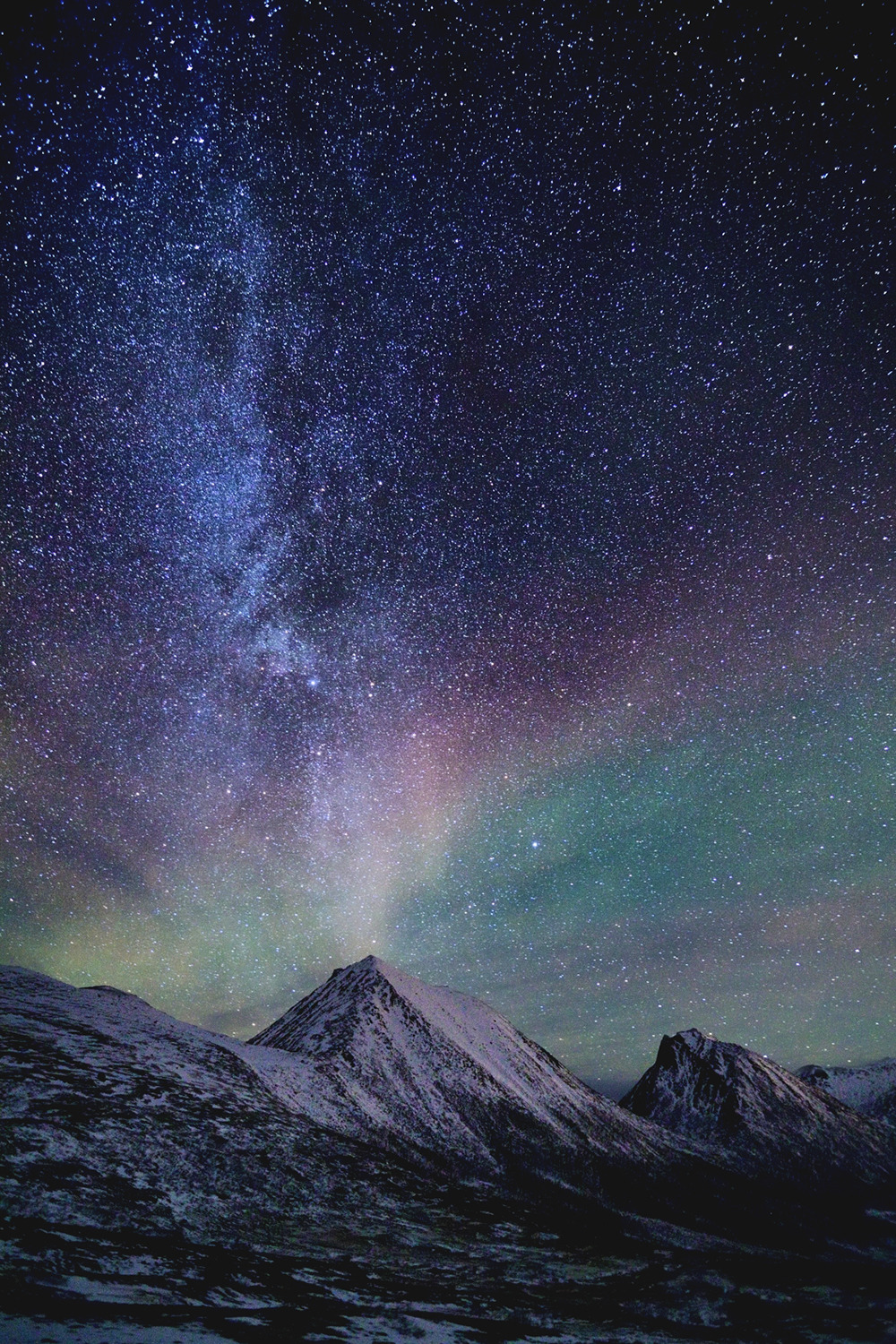 motivationsforlife:  The Milkyway and a faint aurora over Sørtinden in Tromvik by