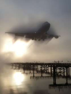 blazepress:  747 breaking through the fog.