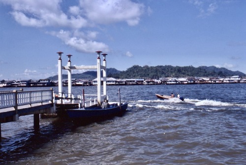 Dock with speedboat and houses on stilts over the water, Bandar Seri Begawan, Brunei (Borneo) - Derm