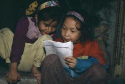 unearthedviews:VIETNAM. Hanoi. Little girls looking at a magazine that provides information on computer methods. 1995.-Bruno Barbey