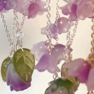purple and pink glass rose jewelry with green leaves