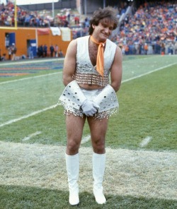 thatofficial70show:   Robin Williams joins the Broncos cheering squad in November 1979, donning a white sequined mini-skirt, go-go boots and an orange neckerchief, then prancing in front of a crowd that the Denver Post pegs at around 74,000 people.  In