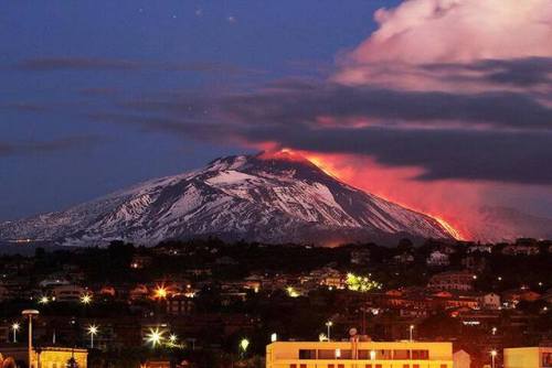 earthstory:  Lava oozing down EtnaMount Etna’s eruptions always seem to photographic wonders. Here we see a glowing lava flow winding its way from the summit of the volcano to the base, illuminating the slopes as the sun sets. Clouds of volcanic gases,