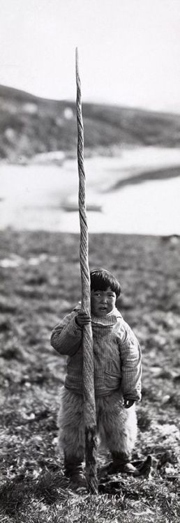 Inuit boy with narwhale tusk, early 20th century.
