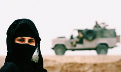 aliirq:An Iraqi Marsh Arab stands as British soldiers patrol in Iraq’s southern marshlands. Basra, Iraq. 2005. © Damir Sagolj