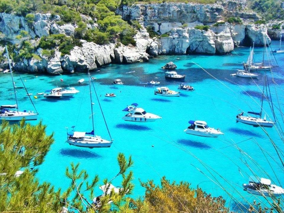 sixpenceee:In Menorca island, the crystal clear water makes the boats appear to fly.