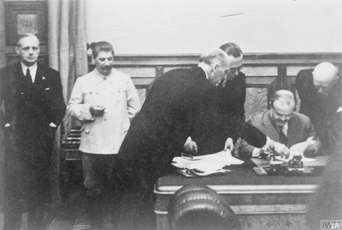 Soviet Foreign Minister Vyacheslav Molotov signs theMolotov-Ribbentrop Pact under the eye of Stalin 