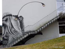culturenlifestyle: A Creatively Creepy Climb Down The Stairs And Into The Jaws of Art Norway based street artist Skurk paints a clever anglerfish which has appropriately positioned light fixtures in its eyes and “angler” to lure people into his work. 