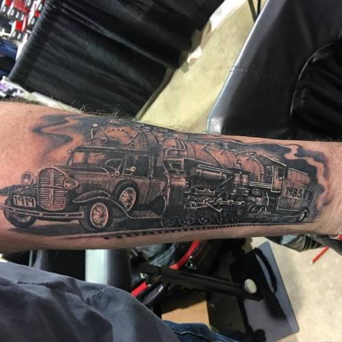 Model A Ford morphed into an old steam engine. This crazy detailed tattoo was done by Half Pint, at 