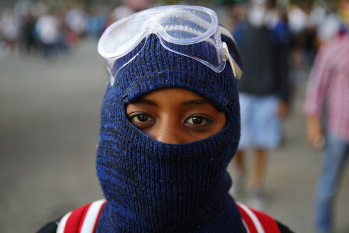 andreinandrea:  A Venezuelan protester poses for a portrait at Altamira square in Caracas. Estos son los estudiantes, que sin armas, protestan en Altamira, municipio Chacao, contra el gobierno de Nicolás Maduro, Jóvenes que luchan y arriesgan sus vidas