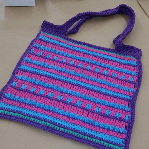 I forgot to take a picture of everyone working on their tote bags tonight, but here’s the first finished one! I love seeing all the color combinations they each chose - they are all unique! #discovercrochet #crochet