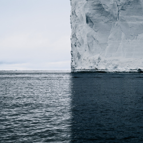 itscolossal:A Towering Iceberg and Its Shadow Split the World into Quadrants