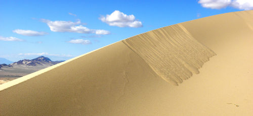 Dune motionSand dunes move due to wind. As air moves rapidly up the slope of a sand dune, it causes 