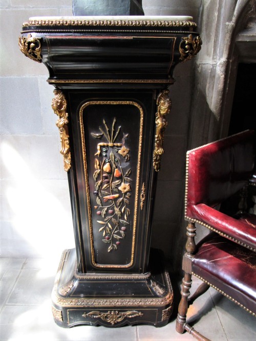 A pedestal cabinet decorated with carved colored stone in the Great Hall at Salisbury House in Des M