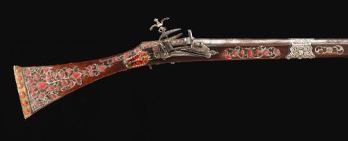 An Algerian miquelet musket decorated with gold, silver, and red coral, 19th century.