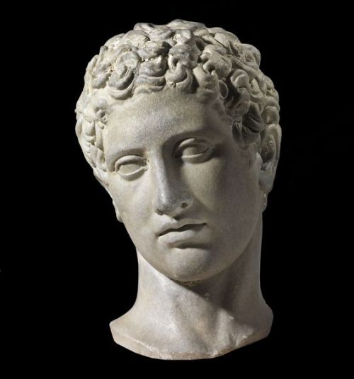 Ancient Roman marble head of a youth, dated to the 1st century CE. The head is a Roman copy of an or