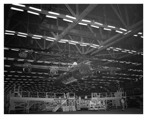 A B-32 fuselage hangs from a monorail on the roof of the Consolidated Vultee factory in Fort Worth, 