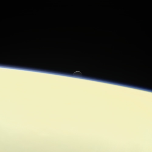 Saturn’s active, ocean-bearing moon Enceladus sinks behind the giant planet in a farewell port