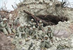 historicaltimes: Battle hardened United States Marines rest for a moment in front of a blown out Japanese coastal gun emplacement during the battle of Iwo Jima, February, 1945. via reddit 