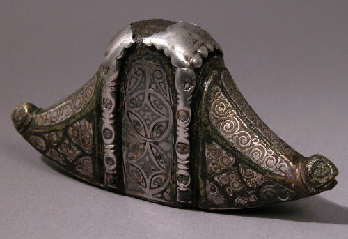 Sword pommel (Anglo-Saxon, late 800s).The quasi-triangular shell of this sword pommel is made of cas