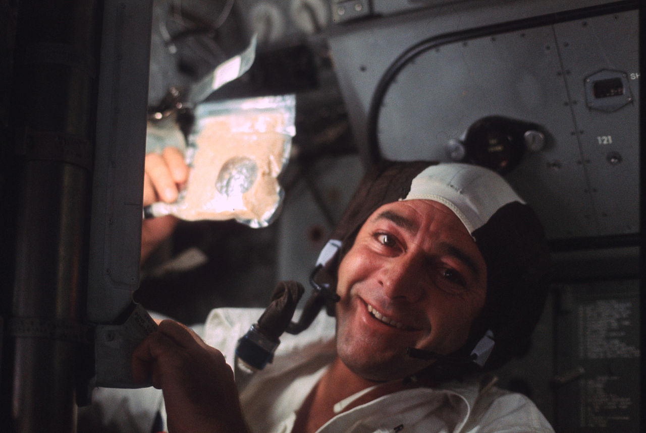 Ron Evans smiles as he holds up a packet of soup during the outbound trip of Apollo 17. Credit: NASA
