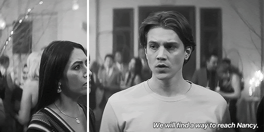GIF FROM EPISODE 3X10 OF NANCY DREW. THE GIF IS SPLIT TO MAKE IT LOOK LIKE TWO DIFFERENT SIZED GIFS. IT'S IN BLACK AND WHITE. ACE AND HANNAH ARE STANDING AT THE CANDLE-LIGHTING CEREMONY. ACE SAYS "WE WILL FIND A WAY TO REACH NANCY."